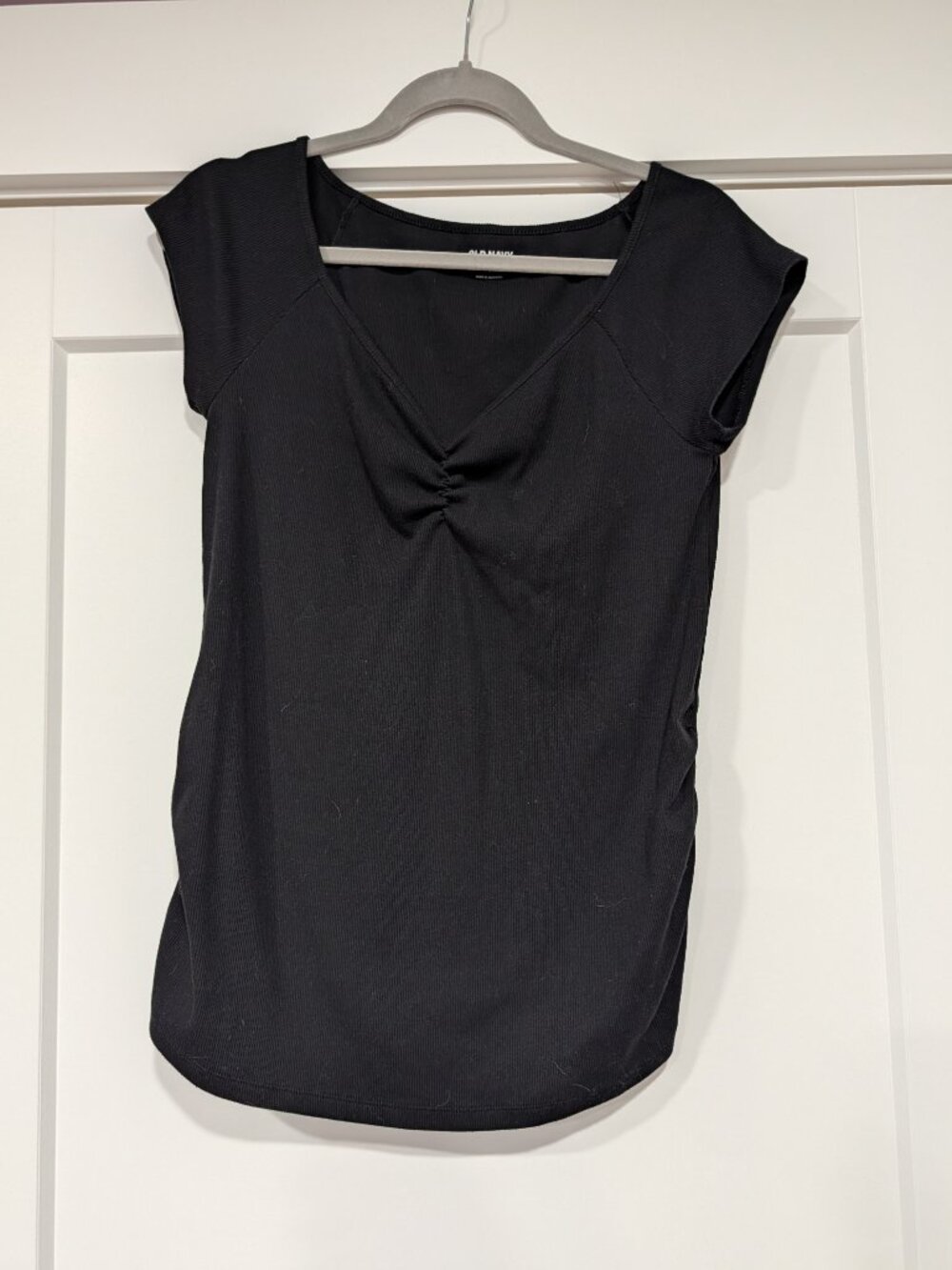 Black v-neck maternity shirt with cap sleeves